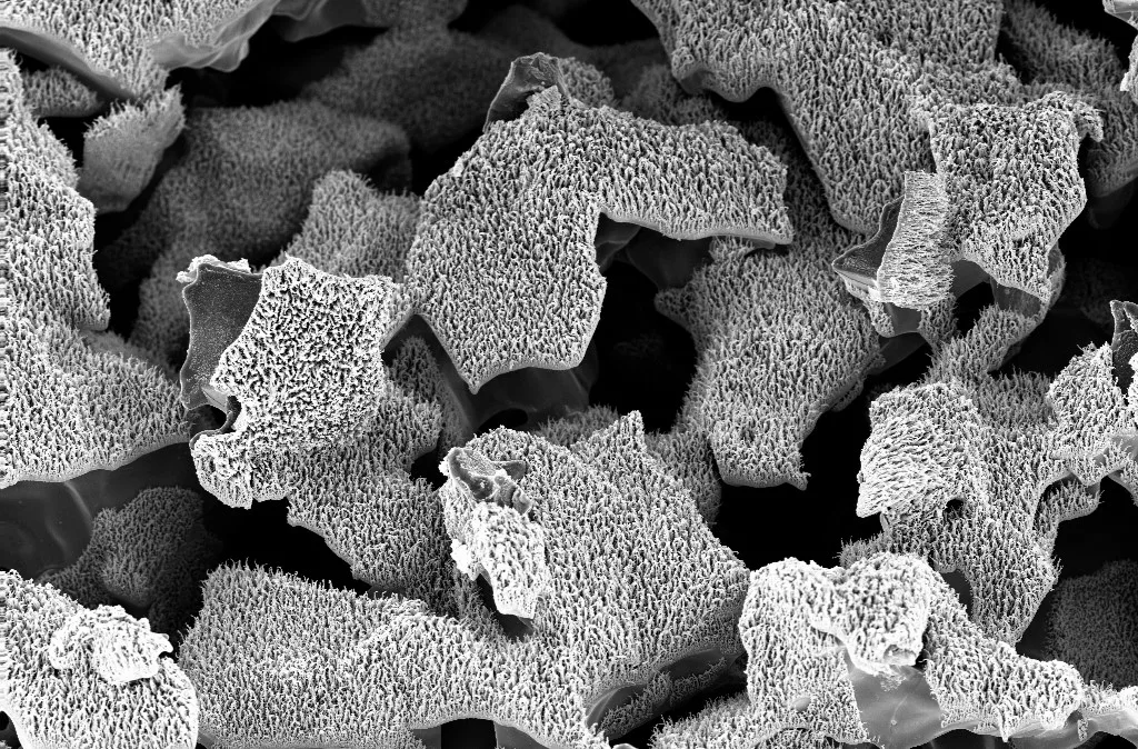Enhancing Efficiency and Durability of PEM Water Electrolysis with Low Iridium Loading through Nanofiber-Modified Porous Transport Electrodes
